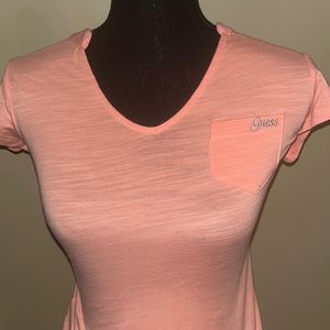 This is a pink Guess t shirt in the size extra small.